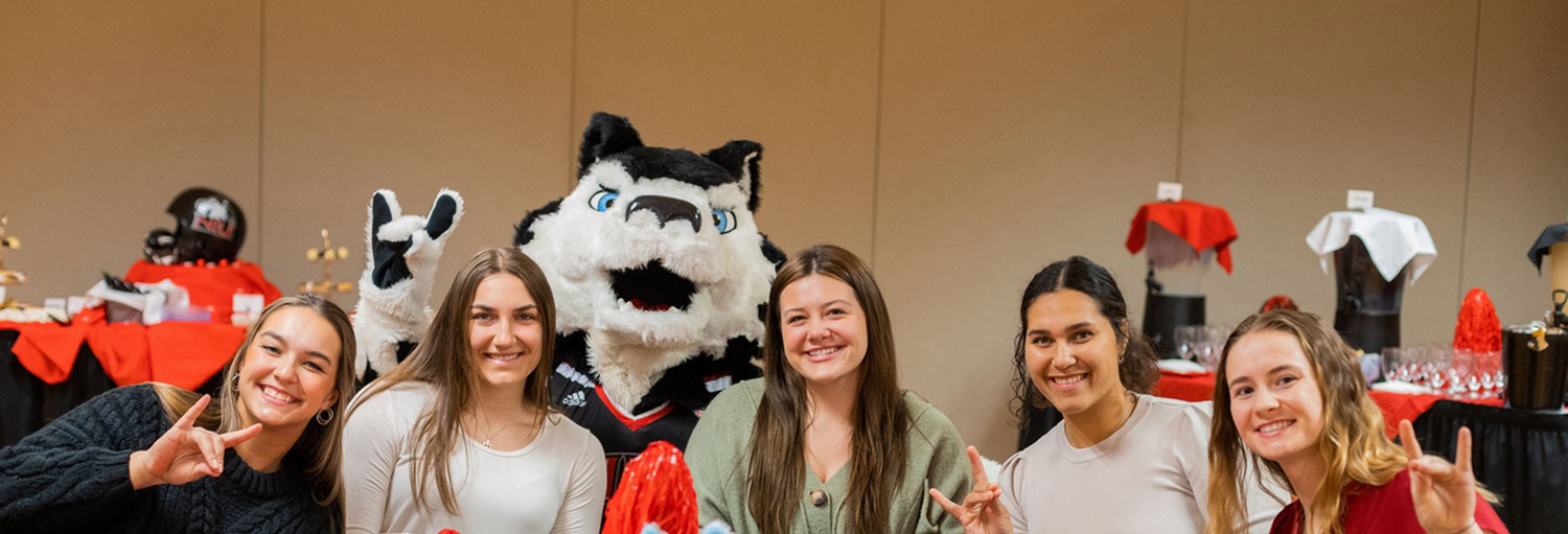 NIU students enjoy a conversation with Victor E Huskie